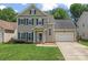 Charming two-story home featuring blue shutters and a well-manicured lawn at 13430 Norseman Ln, Huntersville, NC 28078