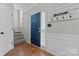 Bright foyer with hardwood floors, a blue front door, and stairway access at 13430 Norseman Ln, Huntersville, NC 28078