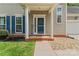 Inviting entryway with a brick pathway, white columns, and a 'Welcome' sign at 13430 Norseman Ln, Huntersville, NC 28078