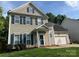 Charming two-story home with neutral siding, blue shutters, and a well-manicured lawn, creating an inviting curb appeal at 13430 Norseman Ln, Huntersville, NC 28078