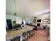 Open kitchen with granite countertops, stainless steel appliances, and bar seating, blending style and functionality at 13430 Norseman Ln, Huntersville, NC 28078