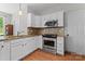Well-lit kitchen featuring stainless steel appliances, granite countertops and white cabinetry at 13430 Norseman Ln, Huntersville, NC 28078