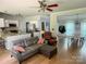 Open-concept living space featuring hardwood floors, kitchen with granite island, and dining area with ample natural light at 13430 Norseman Ln, Huntersville, NC 28078