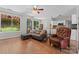 Inviting living area with hardwood floors, comfortable seating, and a seamless transition to the kitchen and outdoor space at 13430 Norseman Ln, Huntersville, NC 28078