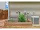 A raised garden with rich vegetation sits on the side of the home's exterior at 13430 Norseman Ln, Huntersville, NC 28078
