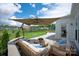 Inviting back patio with cozy couches and an umbrella for shade at 1381 Regions Blvd, Fort Mill, SC 29707