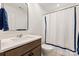Well-lit bathroom with modern vanity, sleek mirror, and a shower with a stylish blue-trimmed curtain at 1381 Regions Blvd, Fort Mill, SC 29707