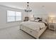 Inviting bedroom with a decorative chandelier, plantation blinds, and a comfortable bed at 1381 Regions Blvd, Fort Mill, SC 29707