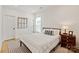 Cozy bedroom with modern decor, featuring a patterned rug, a nightstand and natural light at 1381 Regions Blvd, Fort Mill, SC 29707