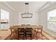 Dining room featuring a stylish modern light fixture, wood table, and neutral color palette at 1381 Regions Blvd, Fort Mill, SC 29707