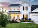 Charming two-story home featuring a welcoming front porch and well-manicured lawn with tasteful landscaping at 1381 Regions Blvd, Fort Mill, SC 29707