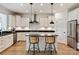 Modern kitchen featuring an island with bar stool seating and stainless steel appliances, all in a well-lit space at 1381 Regions Blvd, Fort Mill, SC 29707