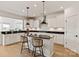 Kitchen featuring an island with bar stool seating and elegant black countertop and modern appliances at 1381 Regions Blvd, Fort Mill, SC 29707