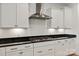 Galley kitchen featuring white cabinetry, dark granite countertops, and stainless steel appliances at 1381 Regions Blvd, Fort Mill, SC 29707