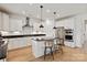 Modern kitchen features stainless steel appliances, granite countertops and a large island with seating at 1381 Regions Blvd, Fort Mill, SC 29707