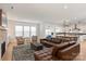 Well-lit living room with large windows, stylish furnishings, and an open floor plan at 1381 Regions Blvd, Fort Mill, SC 29707