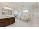 Bright bathroom with quartz counters, frameless shower, and a luxurious soaking tub at 1381 Regions Blvd, Fort Mill, SC 29707