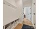 Well-organized mudroom with bench seating, cubbies, coat hooks, and hardwood floors at 1381 Regions Blvd, Fort Mill, SC 29707