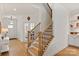 Staircase with hardwood steps, black iron railings, and natural light from the foyer at 1381 Regions Blvd, Fort Mill, SC 29707