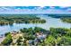 Stunning aerial view of a lakefront property surrounded by lush greenery and sparkling blue waters at 139 Elysian Dr, Mooresville, NC 28117