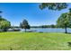Expansive green backyard with a view of the lake and a private dock, ideal for outdoor activities at 139 Elysian Dr, Mooresville, NC 28117