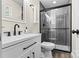 Bathroom features sleek vanity with dark fixtures, and a shower with glass doors at 139 Elysian Dr, Mooresville, NC 28117