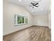 Bedroom features a large window that provides ample natural light and hardwood style floors at 139 Elysian Dr, Mooresville, NC 28117