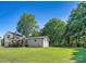 Quaint one-story home with a welcoming front porch, a well-manicured lawn, and mature trees at 139 Elysian Dr, Mooresville, NC 28117
