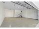 A spacious two car garage featuring epoxy flooring, utility door, and lighting at 139 Elysian Dr, Mooresville, NC 28117