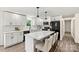 Modern kitchen with white cabinetry, marble countertops, stainless steel appliances, and barstool seating at 139 Elysian Dr, Mooresville, NC 28117