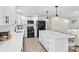 Well-lit kitchen features white cabinets, black appliances, a marble island with bar seating, and sleek finishes at 139 Elysian Dr, Mooresville, NC 28117