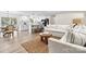Open-concept living room showcases modern white kitchen with island, seating, and wood-style flooring at 139 Elysian Dr, Mooresville, NC 28117