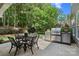 Relaxing outdoor space with built in grill, lush trees and a dining table perfect for entertaining at 15247 Prescott Hill Ave, Charlotte, NC 28277