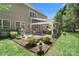 Beautiful backyard featuring a covered patio, outdoor seating, built-in grill and well-manicured landscaping at 15247 Prescott Hill Ave, Charlotte, NC 28277