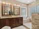 Elegant bathroom featuring double sinks, granite countertops, a walk-in shower, and natural stone tiles at 15247 Prescott Hill Ave, Charlotte, NC 28277