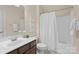 Clean bathroom with white vanity, integrated sink, framed mirror, and shower-tub combination at 15247 Prescott Hill Ave, Charlotte, NC 28277