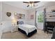 Cozy bedroom with a sports theme featuring a twin bed, wainscoting, and natural light at 15247 Prescott Hill Ave, Charlotte, NC 28277