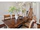 Elegant dining room with a large wooden table, decorative vases, and a view of the staircase at 15247 Prescott Hill Ave, Charlotte, NC 28277