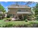 The house features a covered patio, an outdoor kitchen, and a neatly landscaped backyard at 15247 Prescott Hill Ave, Charlotte, NC 28277