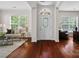 Bright foyer featuring hardwood floors, a decorative front door, and views into the living spaces at 15247 Prescott Hill Ave, Charlotte, NC 28277
