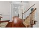 Bright foyer with hardwood floors, white columns, and a staircase with patterned carpet at 15247 Prescott Hill Ave, Charlotte, NC 28277