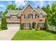 Beautiful brick home with lush lawn, well-manicured landscaping, and charming curb appeal at 15247 Prescott Hill Ave, Charlotte, NC 28277