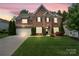 Charming brick two-story home with well-manicured lawn, attached garage and tasteful landscaping at 15247 Prescott Hill Ave, Charlotte, NC 28277