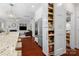 A modern kitchen features stainless steel appliances, a pull-out pantry, and an expansive island at 15247 Prescott Hill Ave, Charlotte, NC 28277