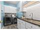 Well-organized laundry room with modern washer/dryer, granite countertop and plenty of storage at 15247 Prescott Hill Ave, Charlotte, NC 28277