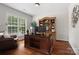 Elegant home office with a large wooden desk, built-in bookcase, and a comfortable leather chair at 15247 Prescott Hill Ave, Charlotte, NC 28277