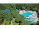 Aerial view of a community pool and tennis courts surrounded by lush trees at 15247 Prescott Hill Ave, Charlotte, NC 28277