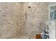 Stylish walk-in shower features beautiful stone tiling, a built-in bench, and multiple showerheads at 15247 Prescott Hill Ave, Charlotte, NC 28277