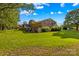 Exterior view of the backyard. A brick home with garage is nestled on a beautiful lush lot at 157 E Meadowview Dr, Statesville, NC 28625