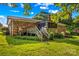 Backyard view showcasing deck, stairs, and screened in porch in lush surroundings at 157 E Meadowview Dr, Statesville, NC 28625